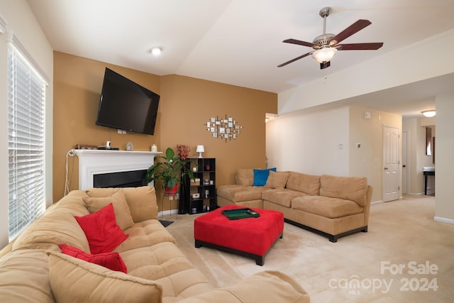 living room featuring light carpet, ceiling fan, and lofted ceiling