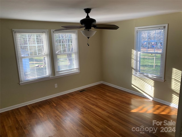 unfurnished room featuring dark hardwood / wood-style floors and ceiling fan