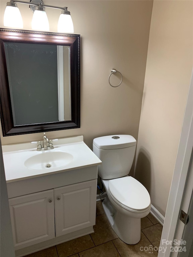 bathroom with tile patterned floors, vanity, and toilet