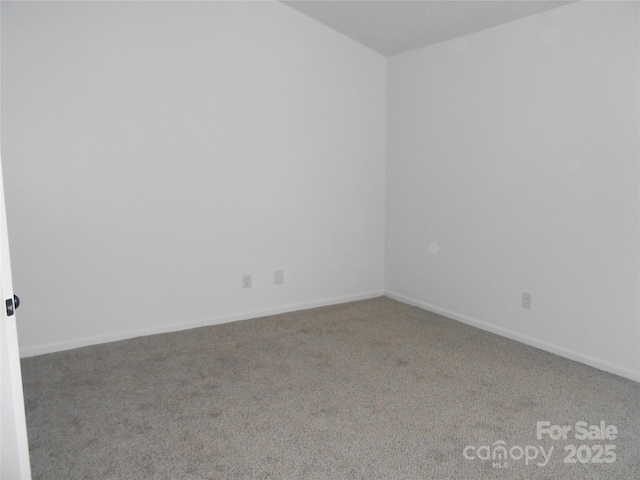 empty room with carpet and baseboards