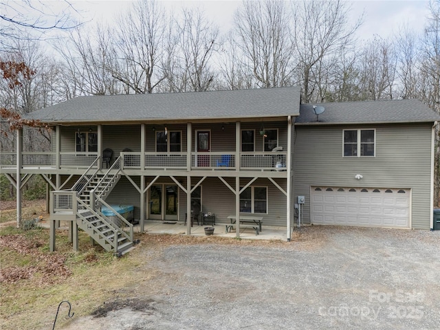 view of front of house featuring a garage and a patio area