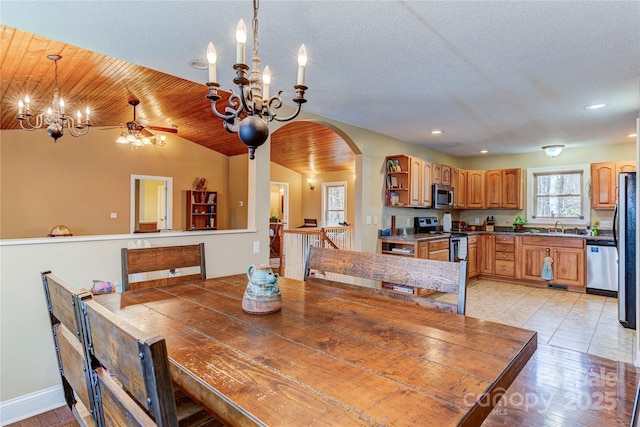 dining area featuring sink, wooden ceiling, a textured ceiling, lofted ceiling, and ceiling fan with notable chandelier