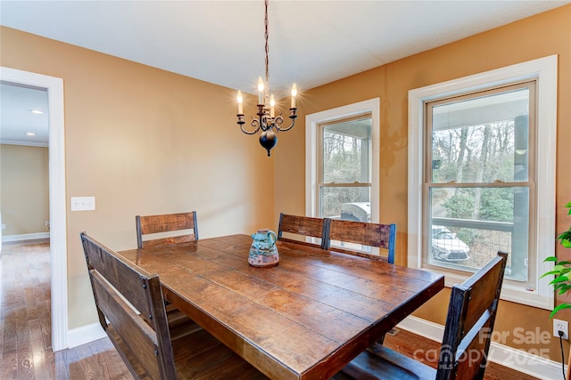 dining area featuring a chandelier and dark wood-type flooring