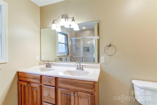 bathroom with vanity, toilet, and walk in shower