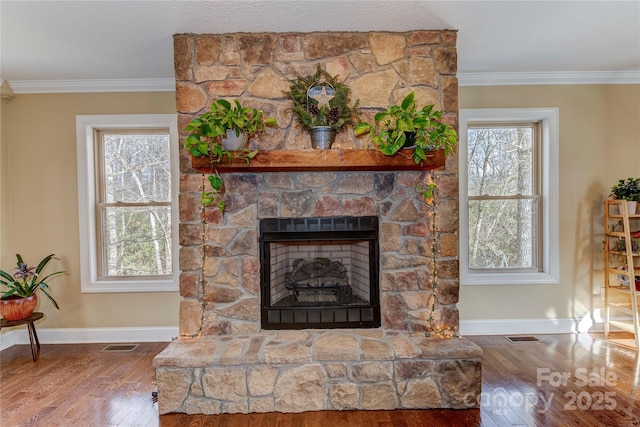 room details with a fireplace, wood-type flooring, and crown molding