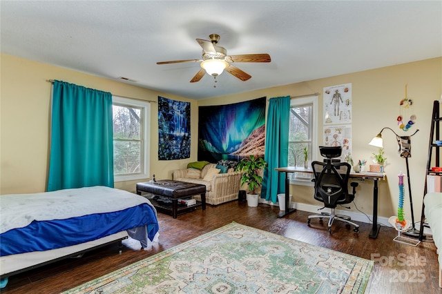 bedroom with dark hardwood / wood-style floors and ceiling fan