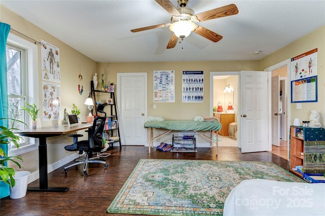 home office with ceiling fan and dark wood-type flooring