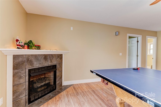 playroom featuring a fireplace and hardwood / wood-style floors