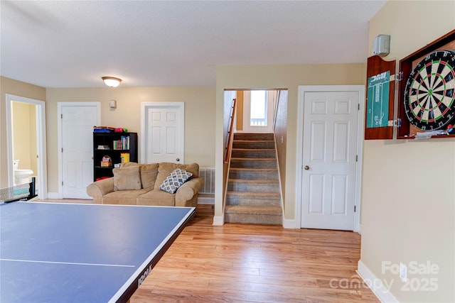 recreation room with wood-type flooring