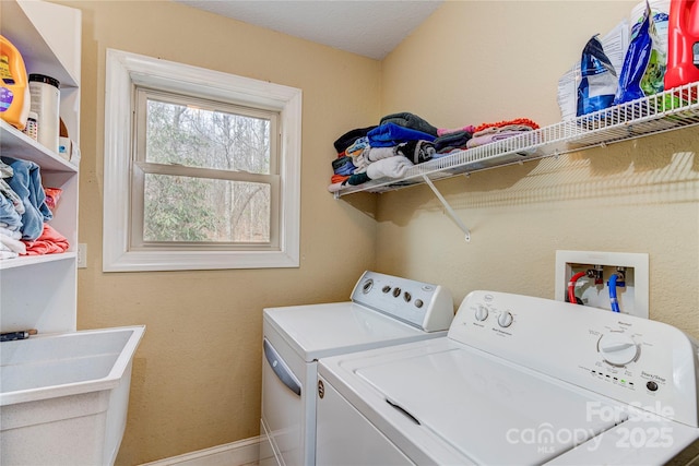 laundry area featuring independent washer and dryer and sink