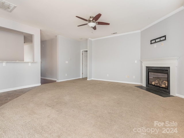 unfurnished living room with carpet flooring, ceiling fan, and crown molding