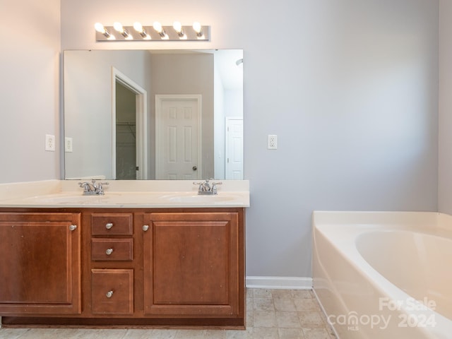 bathroom featuring a washtub and vanity