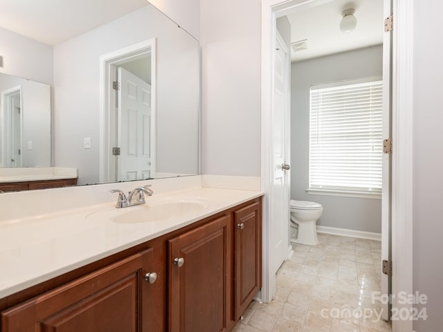 bathroom with vanity and toilet