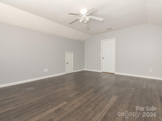 bonus room featuring dark hardwood / wood-style floors, vaulted ceiling, and ceiling fan