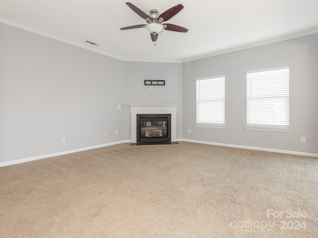 unfurnished living room featuring light carpet, ceiling fan, and crown molding