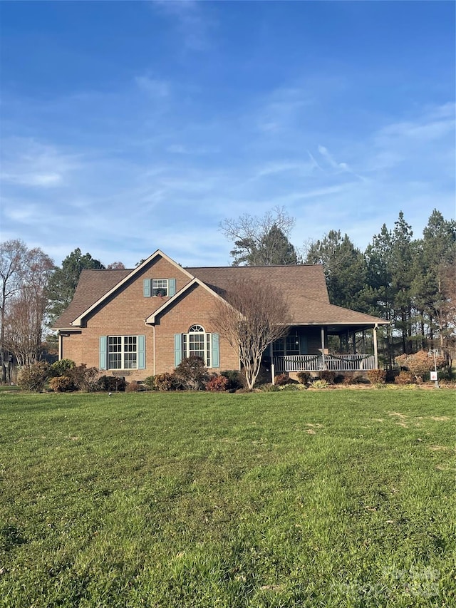 view of front of home with covered porch and a front yard