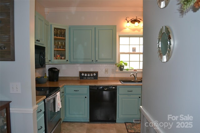 kitchen with sink, backsplash, black appliances, and crown molding