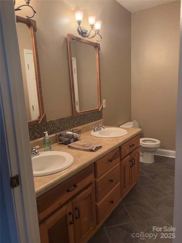 bathroom with vanity, backsplash, toilet, and tile patterned flooring