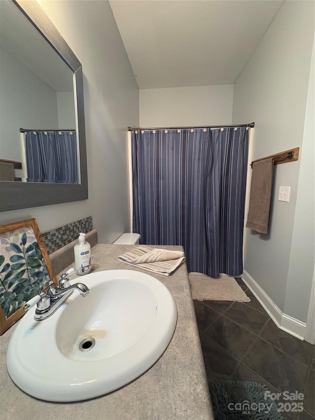 bathroom featuring tile patterned flooring, walk in shower, and vanity