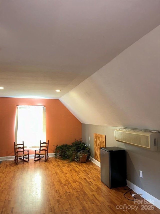 bonus room featuring vaulted ceiling and light hardwood / wood-style flooring