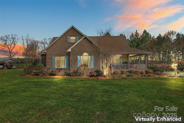 view of front of house featuring a front lawn, a porch, and brick siding