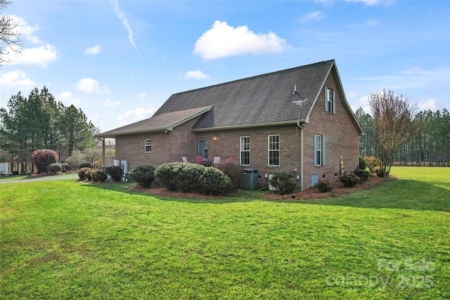 158 White Rd, Wadesboro, NC 28170 - view of home's exterior featuring brick siding, central AC unit, a lawn, and roof with shingles