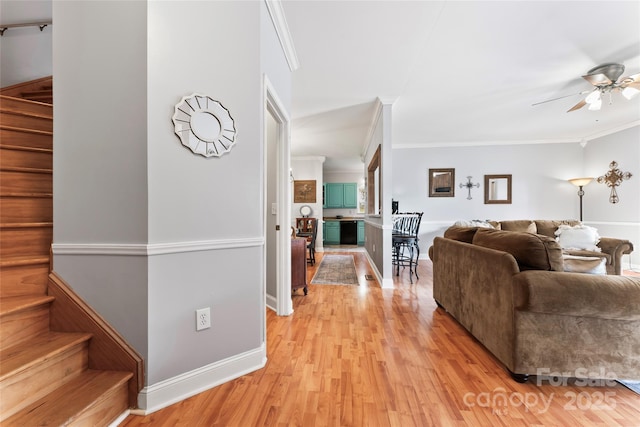 158 White Rd, Wadesboro, NC 28170 - living room featuring light wood finished floors, crown molding, baseboards, ceiling fan, and stairs