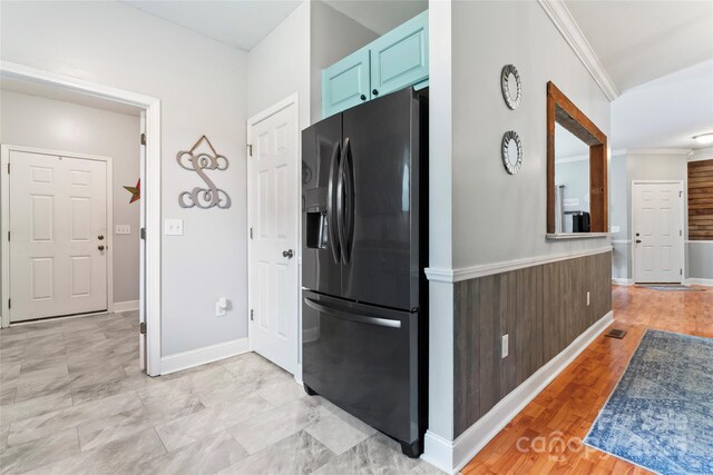 158 White Rd, Wadesboro, NC 28170 - kitchen featuring ornamental molding, blue cabinets, baseboards, and black refrigerator with ice dispenser