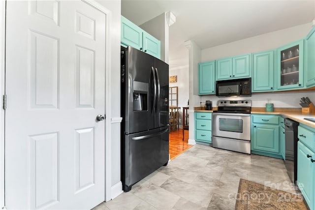 158 White Rd, Wadesboro, NC 28170 - kitchen with glass insert cabinets, blue cabinetry, black appliances, and light countertops