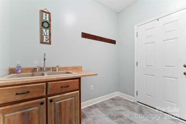 158 White Rd, Wadesboro, NC 28170 - laundry room with baseboards and a sink