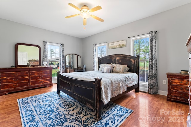 158 White Rd, Wadesboro, NC 28170 - bedroom with multiple windows, baseboards, a ceiling fan, and wood finished floors