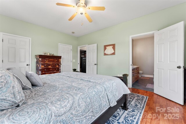 158 White Rd, Wadesboro, NC 28170 - bedroom with ceiling fan, connected bathroom, baseboards, and wood finished floors