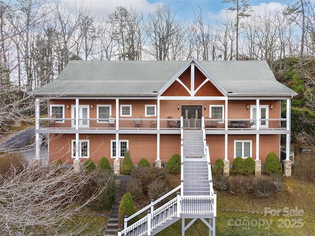 view of front of house featuring stairway and french doors