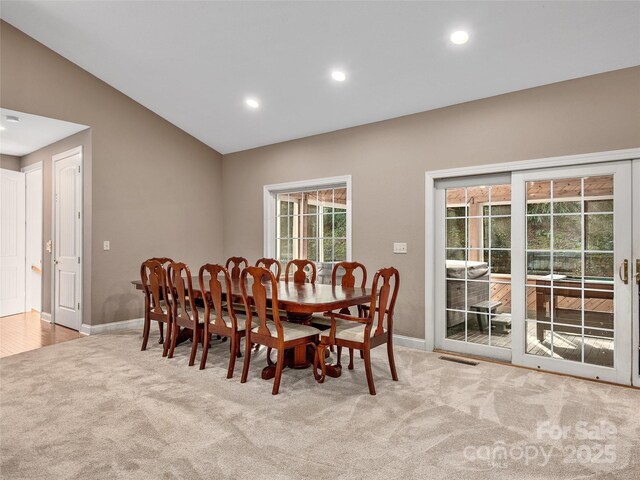 carpeted dining area featuring recessed lighting, visible vents, lofted ceiling, and baseboards