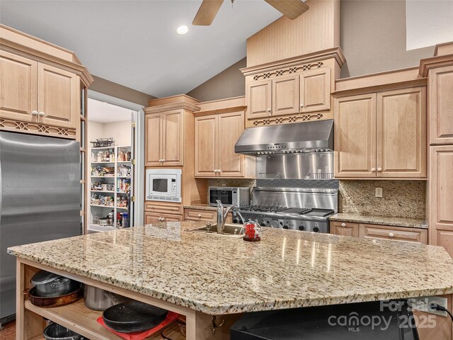 kitchen featuring light brown cabinets, white microwave, open shelves, under cabinet range hood, and stainless steel fridge