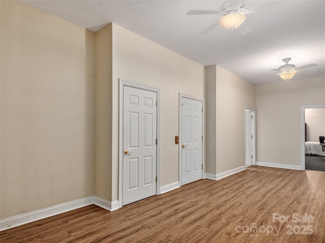 empty room featuring wood finished floors and ceiling fan