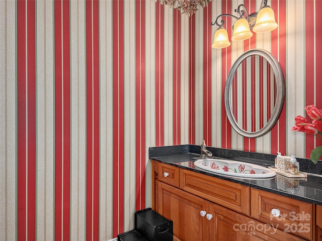 bathroom with wallpapered walls and vanity