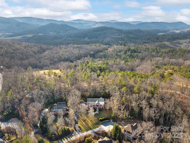 aerial view featuring a mountain view and a wooded view