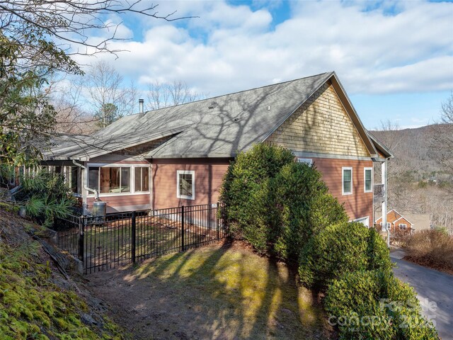 view of side of home with fence