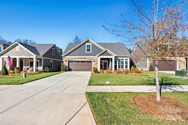 craftsman inspired home featuring a garage and a front lawn