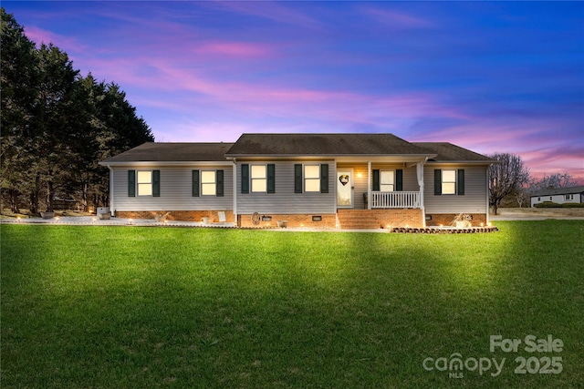 ranch-style house with a lawn and a porch