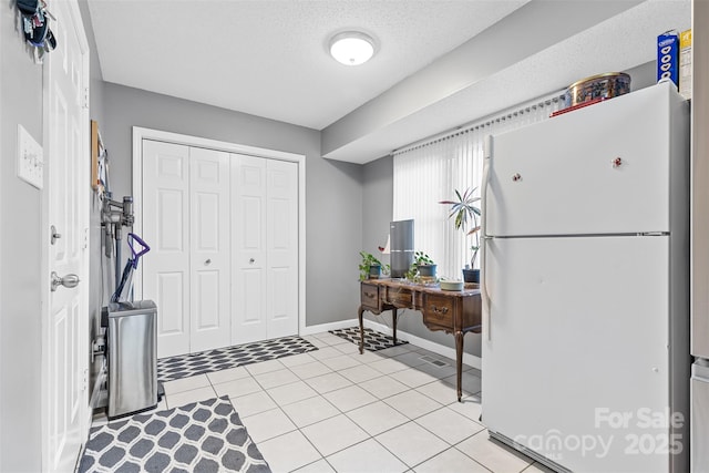 tiled entrance foyer featuring a textured ceiling