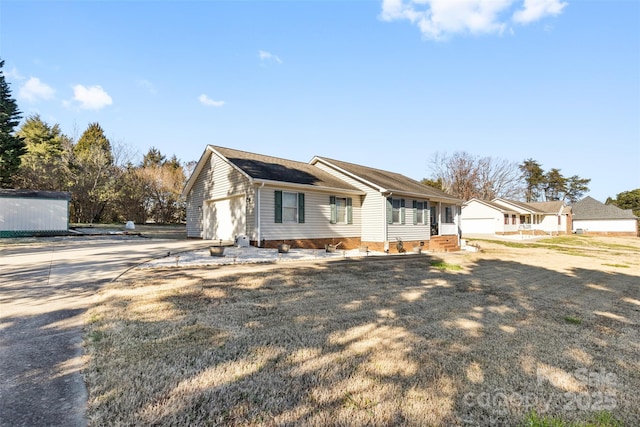 view of front of property with a front yard and a garage