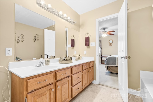 bathroom featuring ceiling fan, a textured ceiling, and vanity