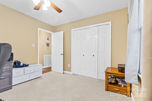 home office with ceiling fan and light carpet