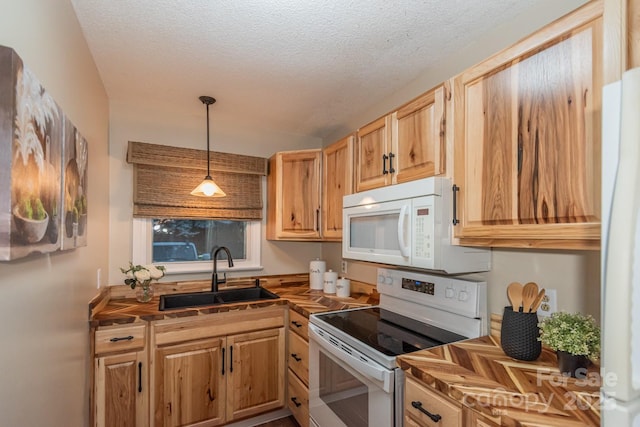 kitchen with sink, light brown cabinets, a textured ceiling, decorative light fixtures, and white appliances