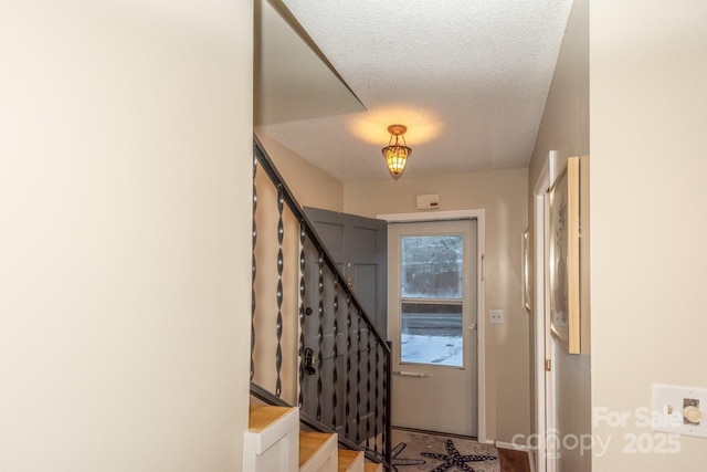 foyer entrance featuring a textured ceiling