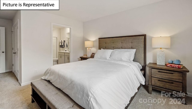 bedroom with connected bathroom and light colored carpet