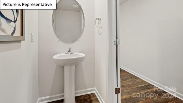 bathroom with wood-type flooring