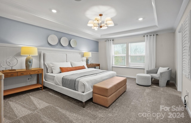 bedroom featuring carpet floors, a raised ceiling, a notable chandelier, and crown molding